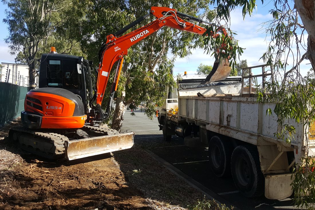 Stafford City — excavator being unloaded for the footpath build